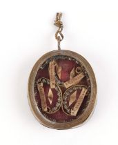 An 18th century religious reliquary locket dedicated to four different saints, mounted on an