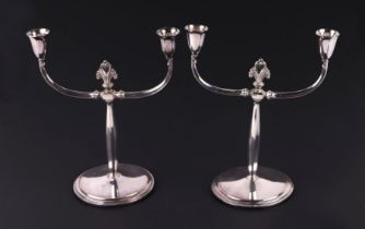 A pair of Danish Atla silver plated twin-arm candelabra, 23cms high; together with a silver plated