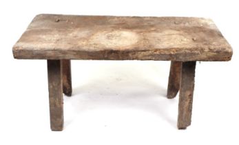 A late 19th century pig bench, the rectangular top on stout rectangular legs, 102cms wide.