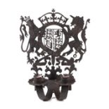 A pierced wrought iron twin-arm candle sconce with Royal Coat of Arms, 30cms high.