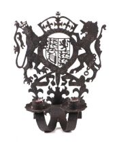 A pierced wrought iron twin-arm candle sconce with Royal Coat of Arms, 30cms high.