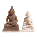 A carved soapstone figure in the form of a Buddha, 10cms high; together with another similar smaller