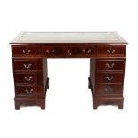 A George III style mahogany veneered pedestal desk with leather inset top and three drawers on