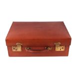 A vintage red leather suitcase, 45cms wide.