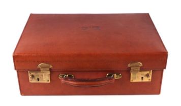 A vintage red leather suitcase, 45cms wide.