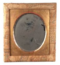 A Liberty style wall mirror with fabric covered frame and oval bevel edged plate, 46cms wide.