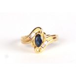 A 9ct gold dress ring set with a central oval sapphire flanked by baguette diamonds, approx UK