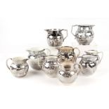 Nine early 19th century silver resist lustre jugs, the largest 14cms high (9). Condition Report