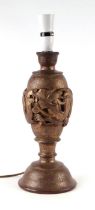An Asian gilt wood table lamp decorated with a dragon, 33cms high.