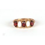 A 9ct gold four-stone garnet and opal ring, approx UK size L, 1.8g.
