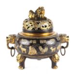 A Chinese bronze censer and cover, the cover with fo dog finial, the body having ring handles and