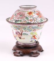 A Chinese enamel bowl and cover on a hardwood stand, decorated with Western style figures, 12cms