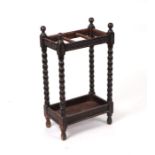 An Edwardian oak hall stick stand with turned bobbin supports, 38cms wide.