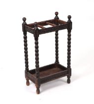 An Edwardian oak hall stick stand with turned bobbin supports, 38cms wide.