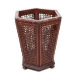 A Regency style waste paper basket of hexagonal form with cane work panels, 36cms wide.