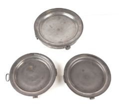 Three early 19th century pewter hot plates, each engraved with an armorial, 26cms diameter (3).