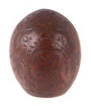 A coconut shell carved Jamaica, palm trees and other leaves, 12cms high. Condition Report The nut