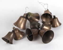 A group of bronze / gun metal graduated bells, the largest 12cms high (11).