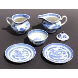 A pair of Chinese blue & white shallow dishes decorated with a pagoda, 15cms diameter; together with