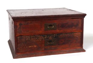 A haberdasher's stained wooden two-drawer chest containing a large amount of sewing related items,