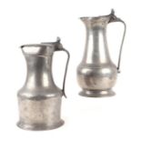 Two early 19th century pewter flagons, one inscribed on the handle 'M Dudouit', 30cms high and 27cms