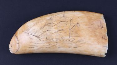 A 19th century whale tooth scrimshaw, one side carved with a ship in full sail, the reverse with a