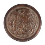 A copper dish decorated in relief with a Neo-classical scene, 31cms diameter.