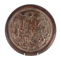 A copper dish decorated in relief with a Neo-classical scene, 31cms diameter.