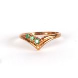 A 9ct gold wishbone ring set with three pale green stones, approx UK size K, 1.3g.