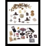 Assorted militaria items to include an ARP tin, cap badges, buttons, flashes, a miniature group of