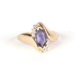 A 9ct gold dress ring set with a large pale blue stone and six diamonds, approx UK size P, 3.3g.