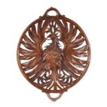 A 19th century carved walnut open work two-handled dish depicting an eagle with outswept wings,