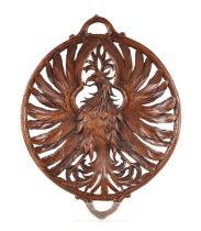 A 19th century carved walnut open work two-handled dish depicting an eagle with outswept wings,