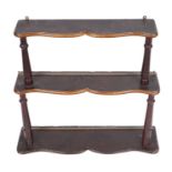 A walnut four-tier wall hanging open bookshelves with turned supports, 60cms wide.