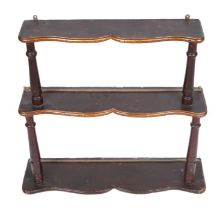 A walnut four-tier wall hanging open bookshelves with turned supports, 60cms wide.