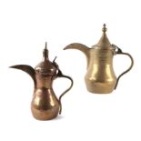 A large brass Islamic / Turkish dallah coffee pot,30cms high; together with a similar smaller, 29cms