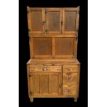 A 1950's oak and ash kitchen cupboard, the superstructure with three cupboards and enamel lined