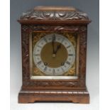An early 20th century walnut bracket clock, the 15cm square brass dial with silvered chapter ring