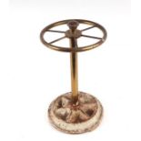 A lacquered brass stick stand wit six divisions and cast iron circular base, 21cms diameter.