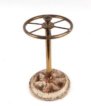 A lacquered brass stick stand wit six divisions and cast iron circular base, 21cms diameter.