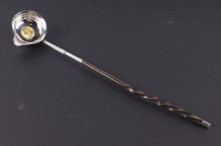 A silver toddy ladle with inset 1758 coin and whale bone handle, 37cms long.