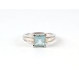 A 9ct white gold ring set with a large square pale blue stone (possibly aquamarine), approx UK
