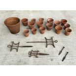 A quantity of terracotta flower pots and line markers.