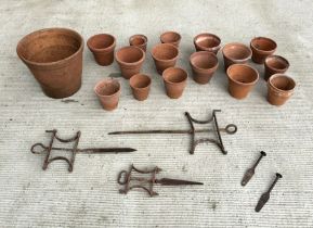 A quantity of terracotta flower pots and line markers.