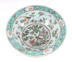 A large Chinese famille rose bowl decorated with birds, flowers and fruit, on a turquoise ground,