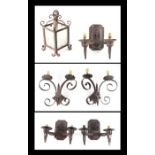 A pair of wrought iron twin-arm wall lights, 34cms wide, three Gothic style wrought twin-arm wall