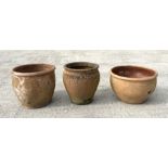 Three large terracotta pickling pots or planters, the largest 33cms high (3).