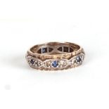 A white and yellow metal eternity ring set with blue & white stones, approx UK size Q, 3.9g.