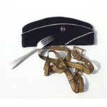 A collection of WWII items including an aluminium fork with Nazi insignia, a forage cap with