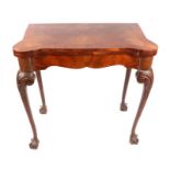 A Queen Anne style walnut card table with carved acanthus leaf cabriole legs, on ball & claw feet,